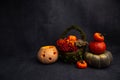 halloween decor, ripe pumpkins, lantern, basket with berries lie on a black background