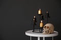 Halloween decor on table near black wall. Idea for festive interior Royalty Free Stock Photo