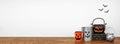 Halloween shelf display with rustic jack o lantern candle holder decor against a white wall Royalty Free Stock Photo