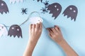 Halloween decorarion. Concept DIY and children creativity. Step-by-step instructions: making garland of ghosts from white and