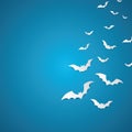 Halloween and decoration concept - white paper bats flying over skyblue background.