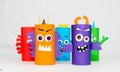 Halloween decoration. DIY and kids creativity concept. Monsters from toilet rolls and colored paper on a white table Royalty Free Stock Photo