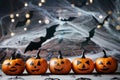 Halloween decoration with funny pumpkin heads, spider, web and flying bat on mystical background.