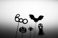 Halloween Decoration. Shadows pumpkin, bat, ghost, spider, and Boo word on the gray background.