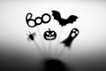 Halloween Decoration. Shadows pumpkin, bat, ghost, spider, and Boo word on the gray background.