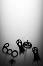 Halloween Decoration. Terrifying Shadow Puppets. Shadows pumpkin, ghost, spider, and Boo word on the gray background.