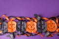 Halloween decorations on bright purple background. Halloween concept. Flat lay, top view, copy space. Party garland and handmade