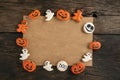 Halloween decorations on brown background. Frame from delicious soft gingerbread cookie. Copy space. Halloween concept