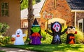 Halloween decorations - Goblins and spooks in the neighborhood - cute ghost witch skeleton with boo sign and vampire in front of Royalty Free Stock Photo