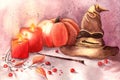 Halloween decorations with Gryffindor hat , pumpkin, red berries, two red candles and Harry Potter magic wand. Royalty Free Stock Photo