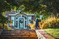 Halloween decorations surrounding steps and home entrance in beautifully landscaped property