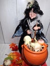 Halloween scary witch with cauldron of skeleton bones, skulls, eyeballs, spiders
