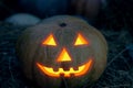 Halloween design carved out of pumpkin ominous face flashlight jack burning smile in the dark