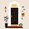 Halloween design. Entrance door decorated for Halloween. Carved black and white pumpkins, bats, spiderweb near black front door.