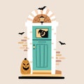 Halloween design. Entrance door decorated for Halloween. Carved pumpkin, bats, spiderweb and ghost silhouette near front door.