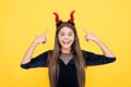 Halloween devil girl. happy childhood. watch my horns. funny teenage child in imp horns. cheerful kid having fun