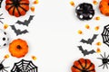 Halloween double side border flat lay of pumpkins, candy and decor, over a white background Royalty Free Stock Photo