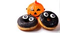 Halloween doughnuts with eyes and pumpkin isolated over white background Royalty Free Stock Photo