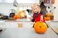 Halloween dressed girl creating pumpkin Jack-O-Lantern Royalty Free Stock Photo