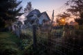 Halloween-dressed home facade with cobwebs, spiders, and paper bats, in warm sunset glow. Royalty Free Stock Photo