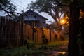 Halloween-dressed home facade with cobwebs, spiders, and paper bats, in warm sunset glow. Royalty Free Stock Photo