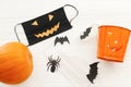 Halloween evil face mask, pumpkin, disinfection gel bottle, jack o lantern pail, bat and spider Royalty Free Stock Photo