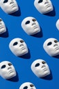 Halloween face mask pattern on blue background. Minimal holiday season concept. Flat lay Royalty Free Stock Photo