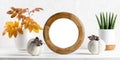 Halloween, fall, thanksgiving banner. Round frame, house plants, ceramic pumpkins, leaves on white.