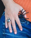 Halloween female hand with spider and skull ring