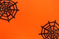 Halloween festive concept. Decorative spider net on a bright orange background. Flat lay, copy space Royalty Free Stock Photo