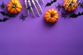 Halloween flat lay composition with pumpkins, bony hands, spiders, bats on purple background. Happy halloween banner mockup