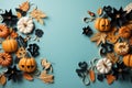 Halloween frame with party decorations of pumpkins, bats, ghosts, spiders on blue background from above. Happy halloween card in Royalty Free Stock Photo