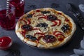 Halloween funny pizza with spiders, Creative idea for Halloween pizza on dark background with drinks and decorations