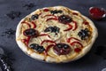 Halloween funny pizza with spiders, Creative idea for Halloween pizza on dark gray background with decorations