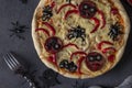 Halloween funny pizza with spiders, Creative idea for Halloween pizza on dark gray background, Top view