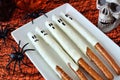 Halloween ghost candy dipped pretzel rods, close up on plate