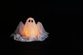 Halloween ghost of starch and gauze on black background. Gift idea, decor Halloween