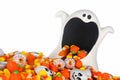 Halloween ghost wide mouth bowl with spilling candy pile isolated on white