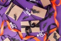 Halloween gift boxes with ribbon and paper decoration on traditional purple background. Holiday, Birthday, Halloween party