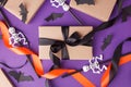 Halloween gift boxes with ribbon and paper decoration on traditional purple background. Holiday, Birthday, Halloween party