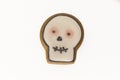 Halloween gingerbread cookie with icing in shape of a skull. Isolated close up top view shot on a white background Royalty Free Stock Photo