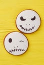 Halloween gingerbread cookies on yellow background.