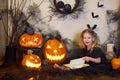 girl reads book spells. Halloween blonde witch. Magic wand in hands of magician.