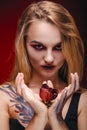 Halloween girl vampire with red eyes red lips and red background Royalty Free Stock Photo