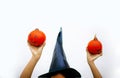 Halloween girl witch in hat holding pumpkin in hand Royalty Free Stock Photo