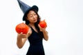 Halloween girl witch in hat holding pumpkin in hand Royalty Free Stock Photo