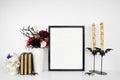 Halloween gothic romance mock up black frame on a white shelf with red and black flowers, skull, books and candles Royalty Free Stock Photo