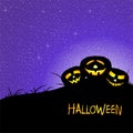 Halloween greeting with two illuminating pumpkins on meadow with grass with shining dark night sky with stars and yellow inscripti