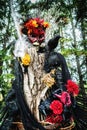 Beautiful terrifying Halloween character with crows flowers skull and a piece of tree bark copy