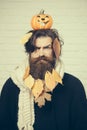 Halloween hipster frown with yellow leaves in beard hair